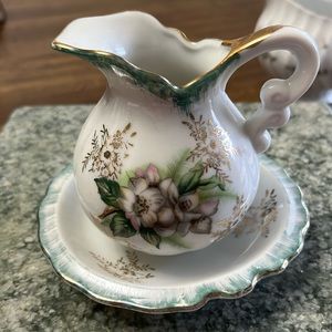 Pitcher and plate are miniature in size.